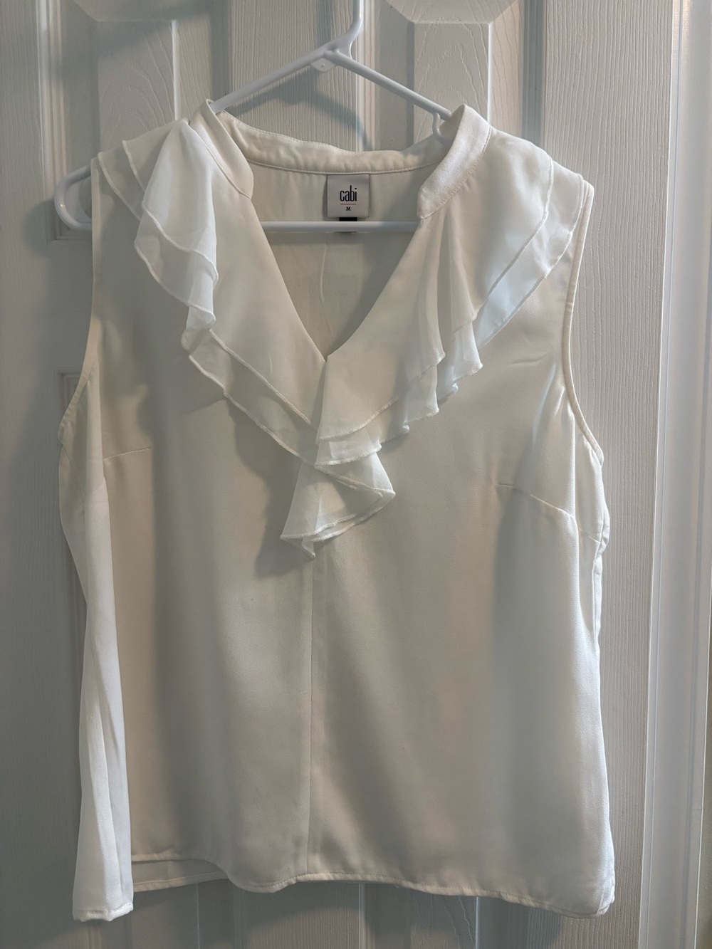 Cabi Portrait Blouse
White Ruffle V-Neck Sleeveless